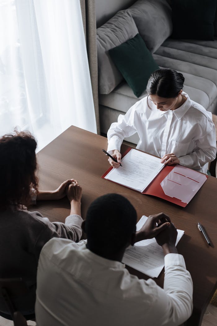 contact-img Business professionals in a meeting reviewing documents at a table.